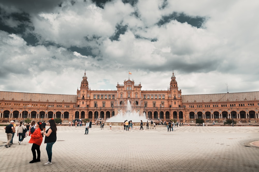 a group of people walking in front of a building