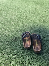 "Empty shoes on spotless artificial turf, representing the freedom to relax in a yard meticulously c