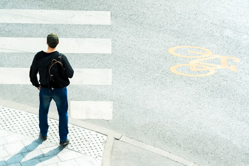 a man standing in front of a crosswalk