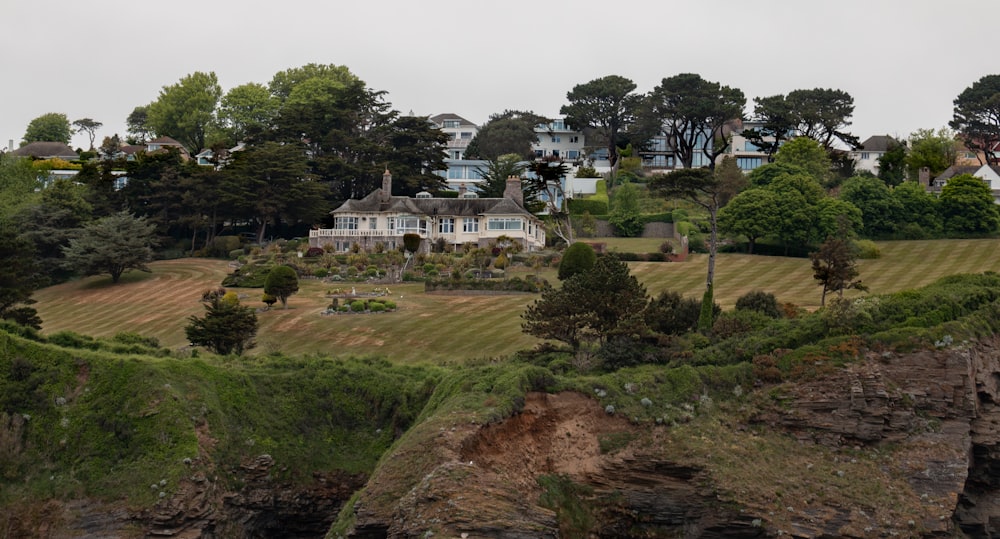 a large house with trees and grass