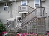 Exterior of a residential home with a fresh coat of light gray paint and white shutters.