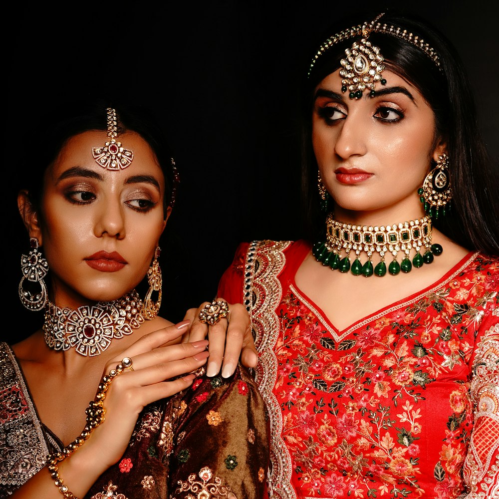 a couple of women wearing traditional indian clothing