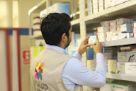 a man taking a picture of a product in a store