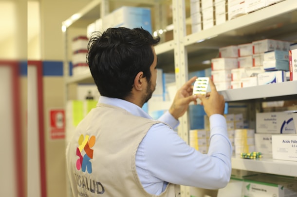 a pharmacist who taking a picture of a product in a store
