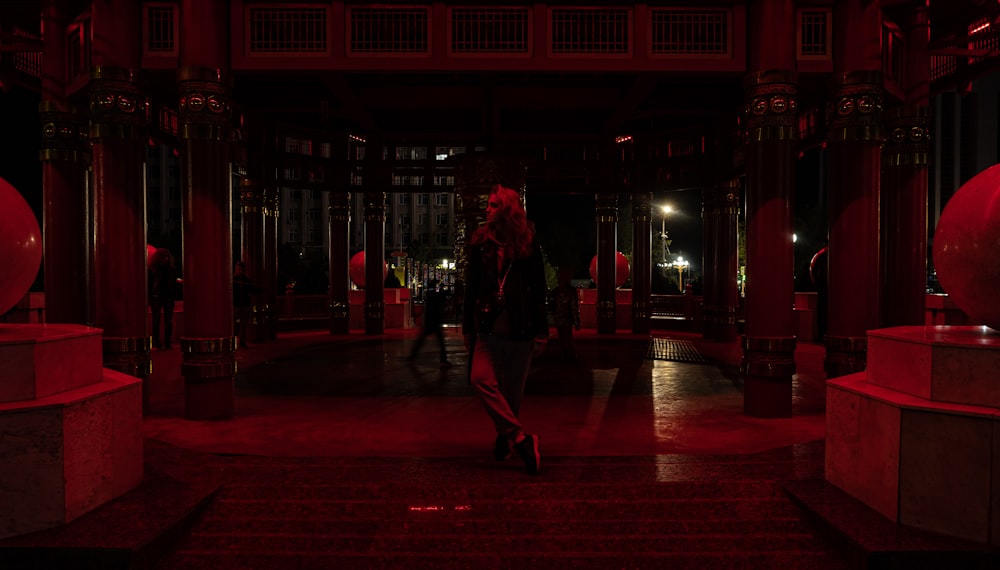 a person walking in a red lit room