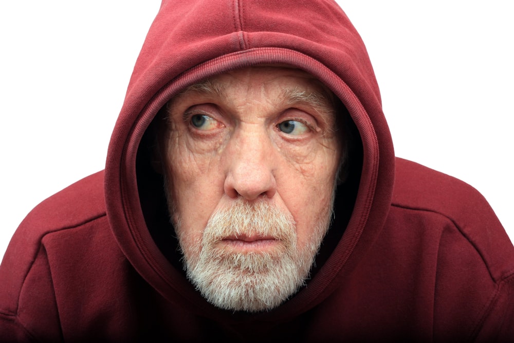 a man wearing a red hood