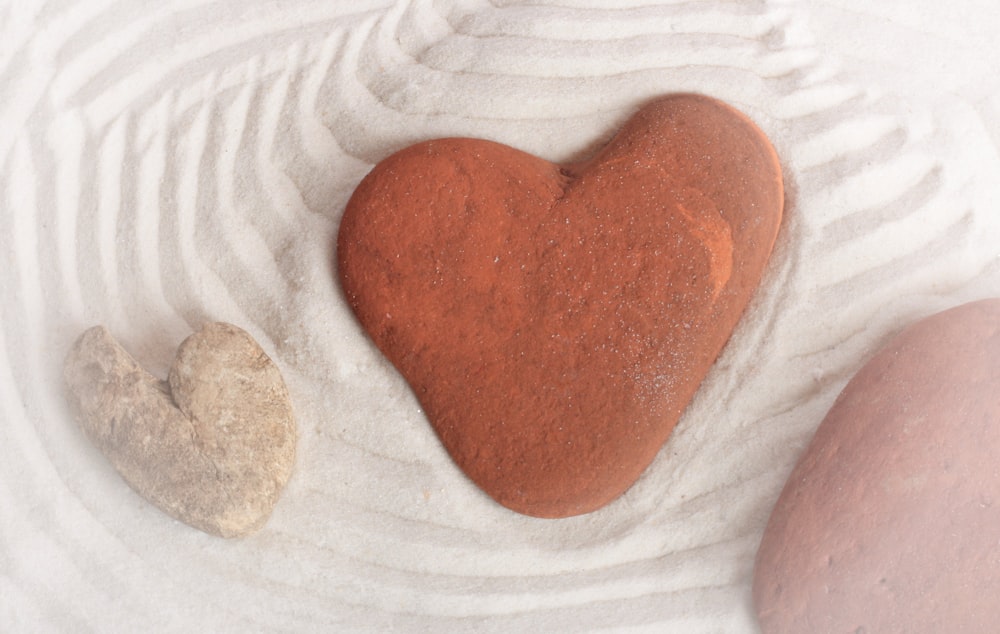 a hand holding a heart shaped object