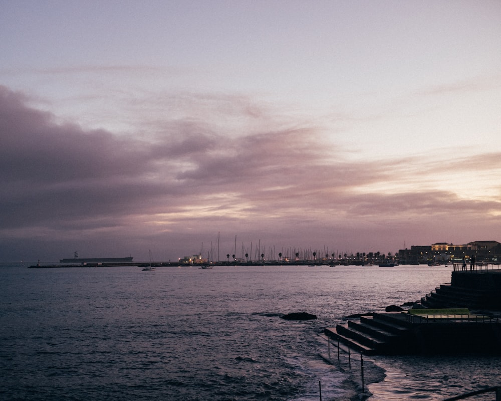 a body of water with boats in it and a city in the distance