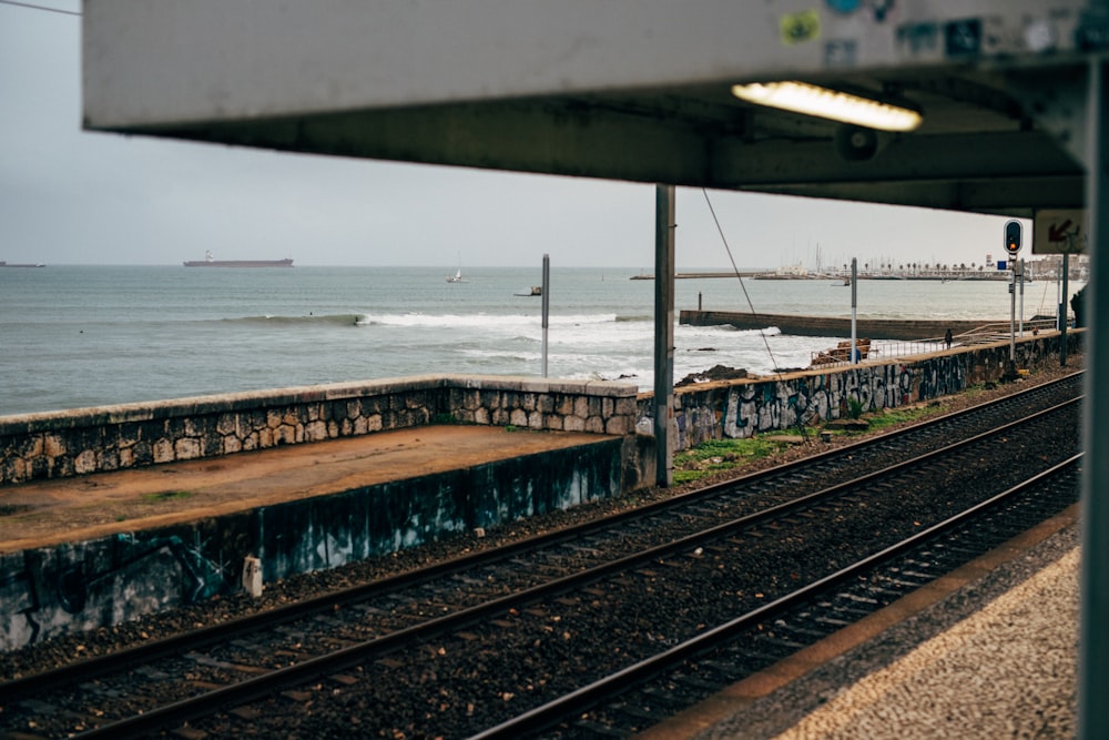 train tracks next to a body of water