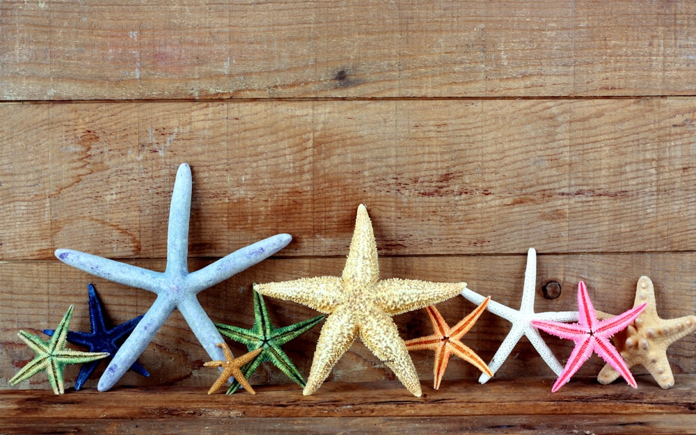 a group of small star shaped objects on a wood surface