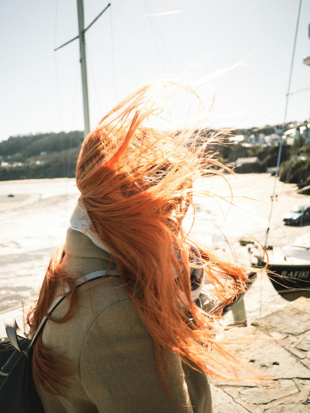 a person with the hair blowing in the wind