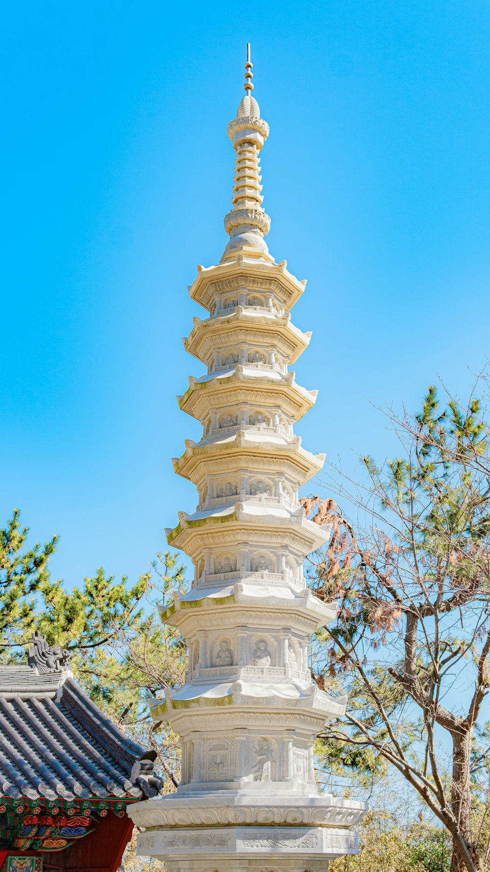 a tall tower with a pointed top with Telstra Tower in the background