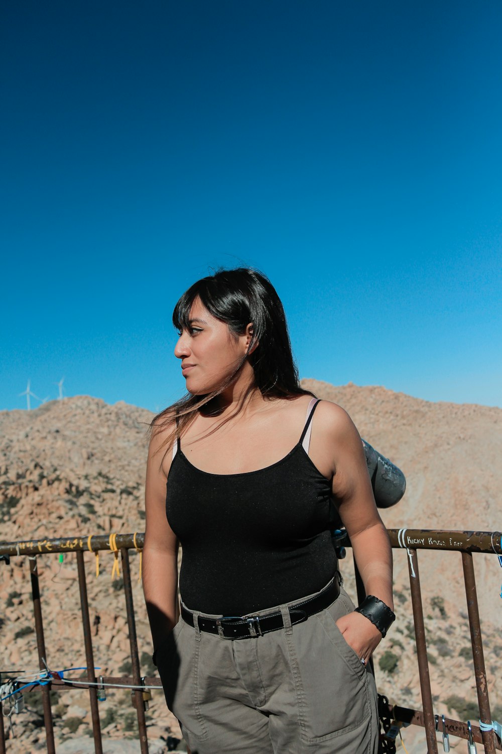 a woman standing on a bridge