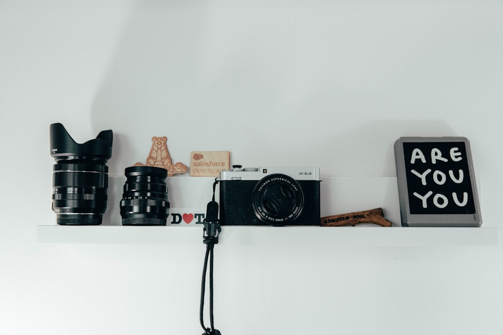 a shelf with a camera and other objects on it