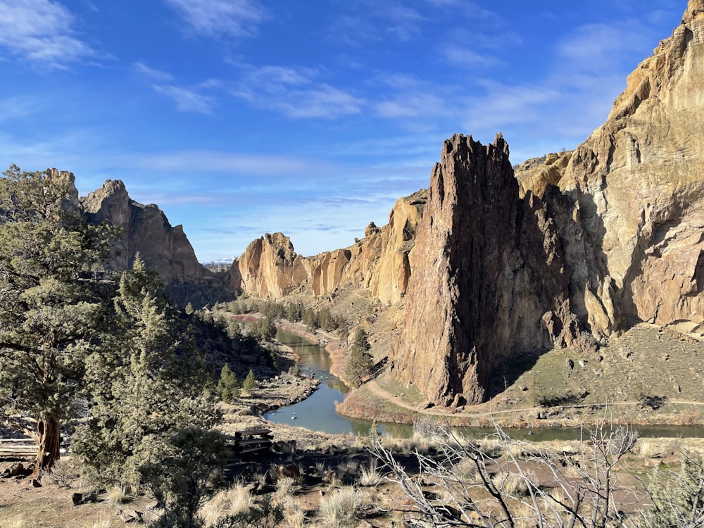 a river running through a canyon with Smith Rock State Park in the background