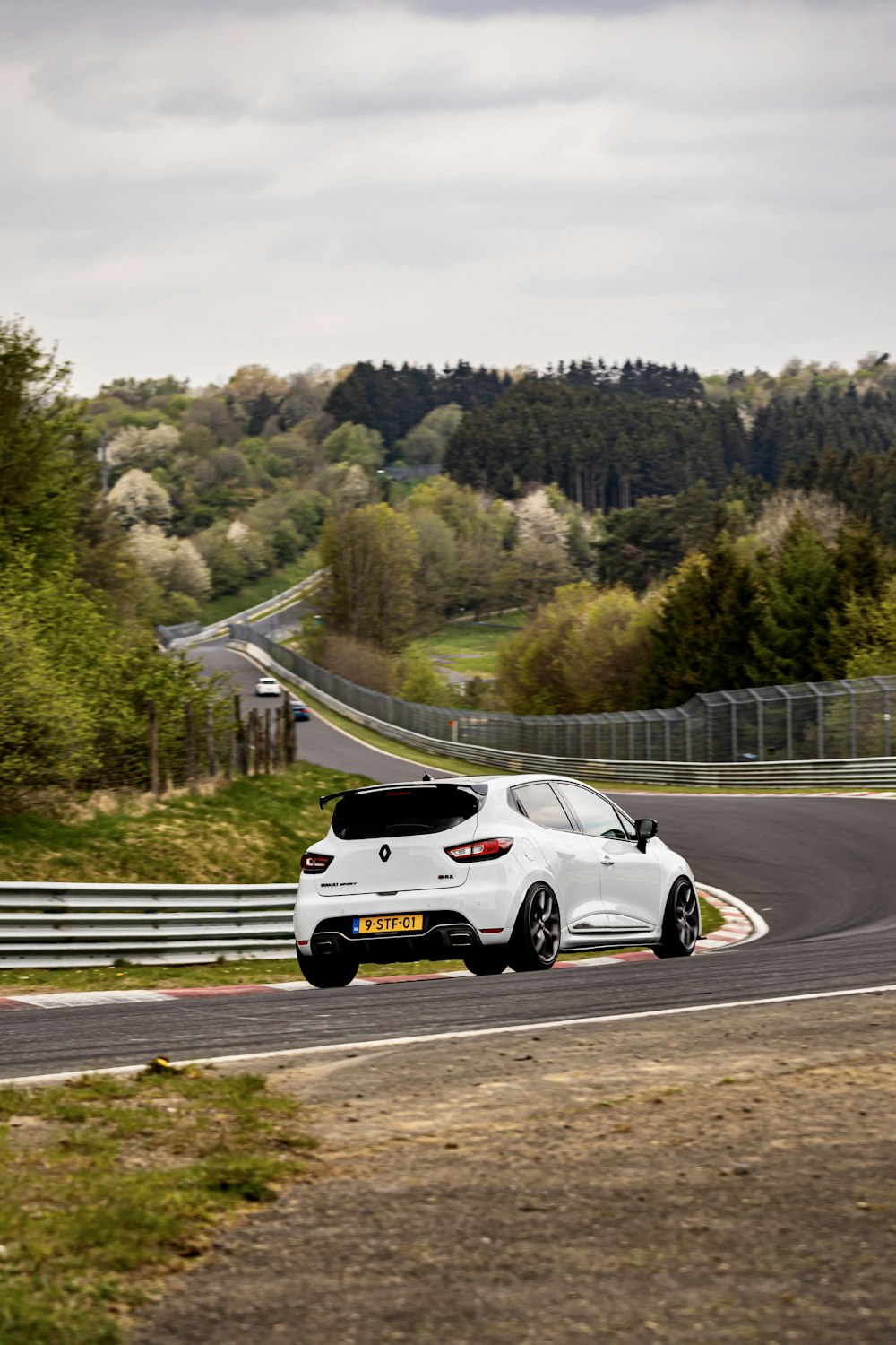 a white sports car on a road