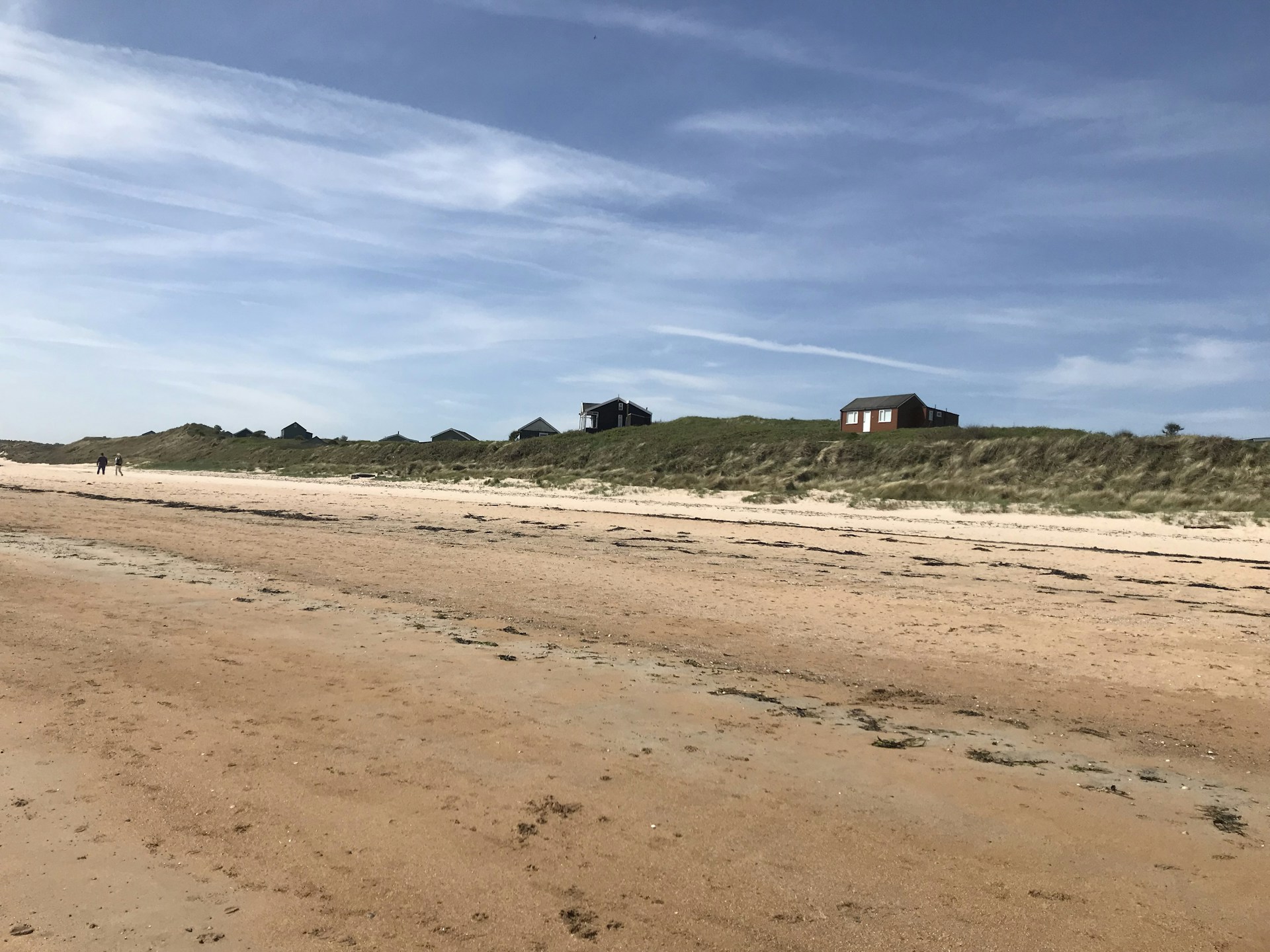 woman wearing yellow long-sleeved dress under white clouds and blue sky during daytime