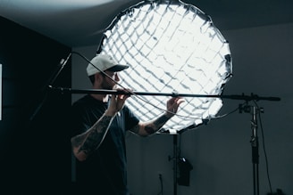 a photographer in a studio adjusting his tools