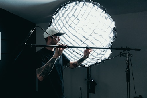 a photographer in a studio adjusting his tools