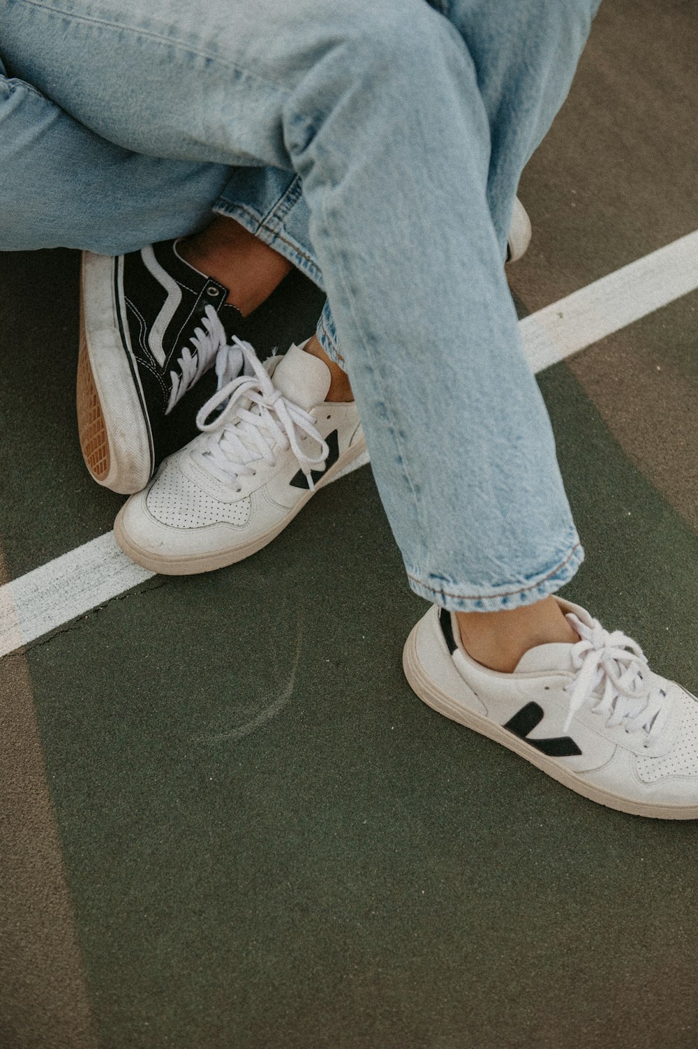 a pair of legs with white sneakers