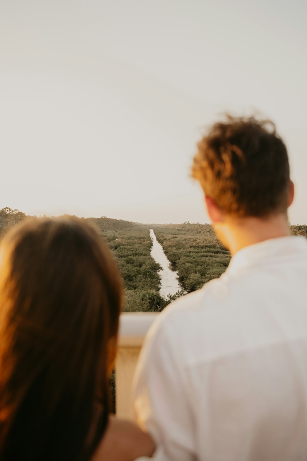 a man and woman looking at a waterfall