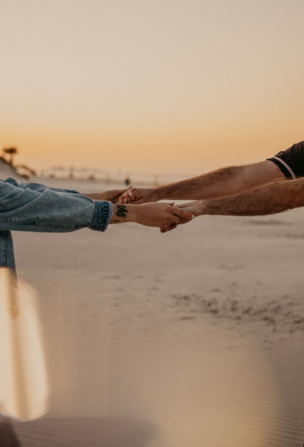 a person's hand on a beach