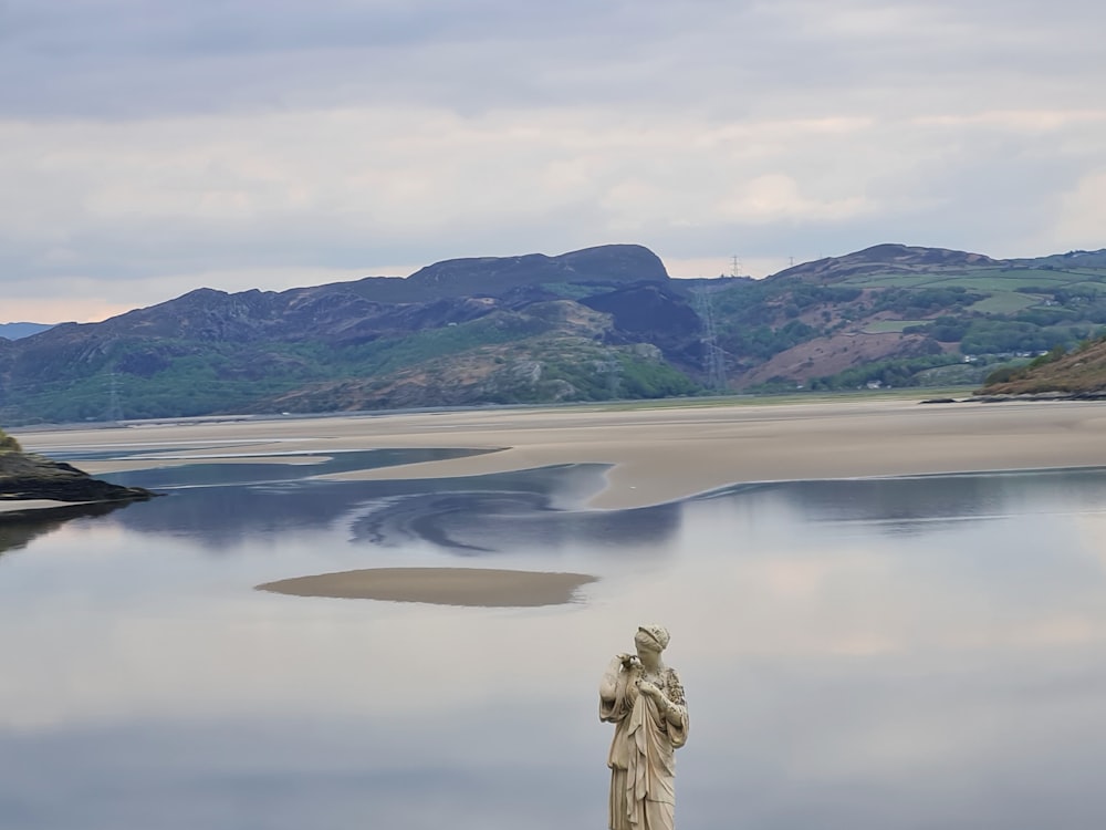 a body of water with mountains in the background