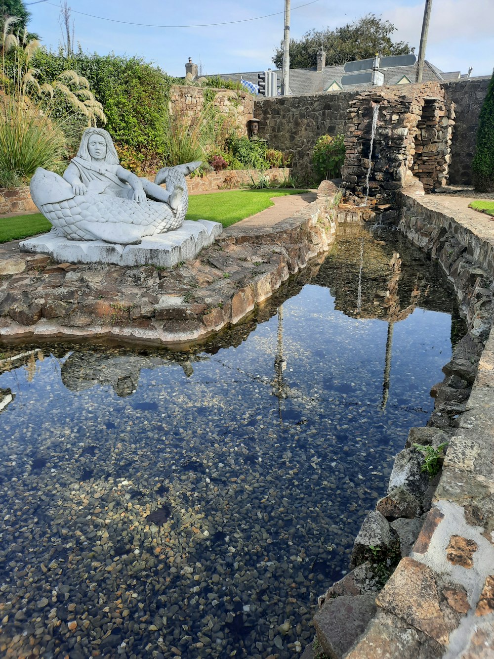 a statue in a pond