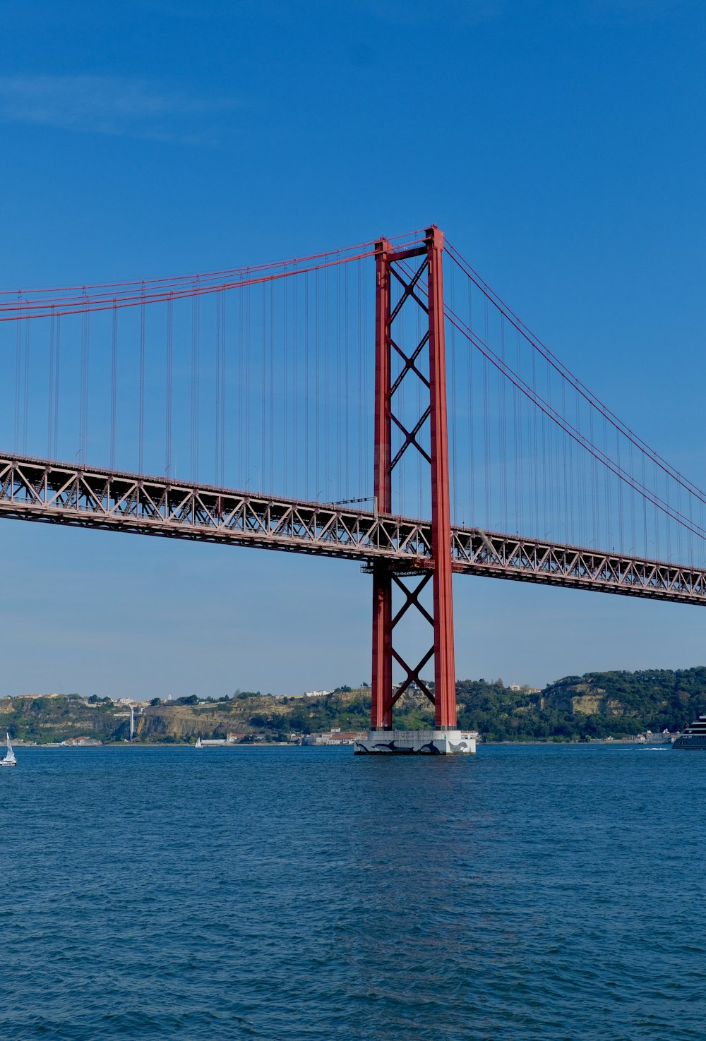 a large red bridge over water