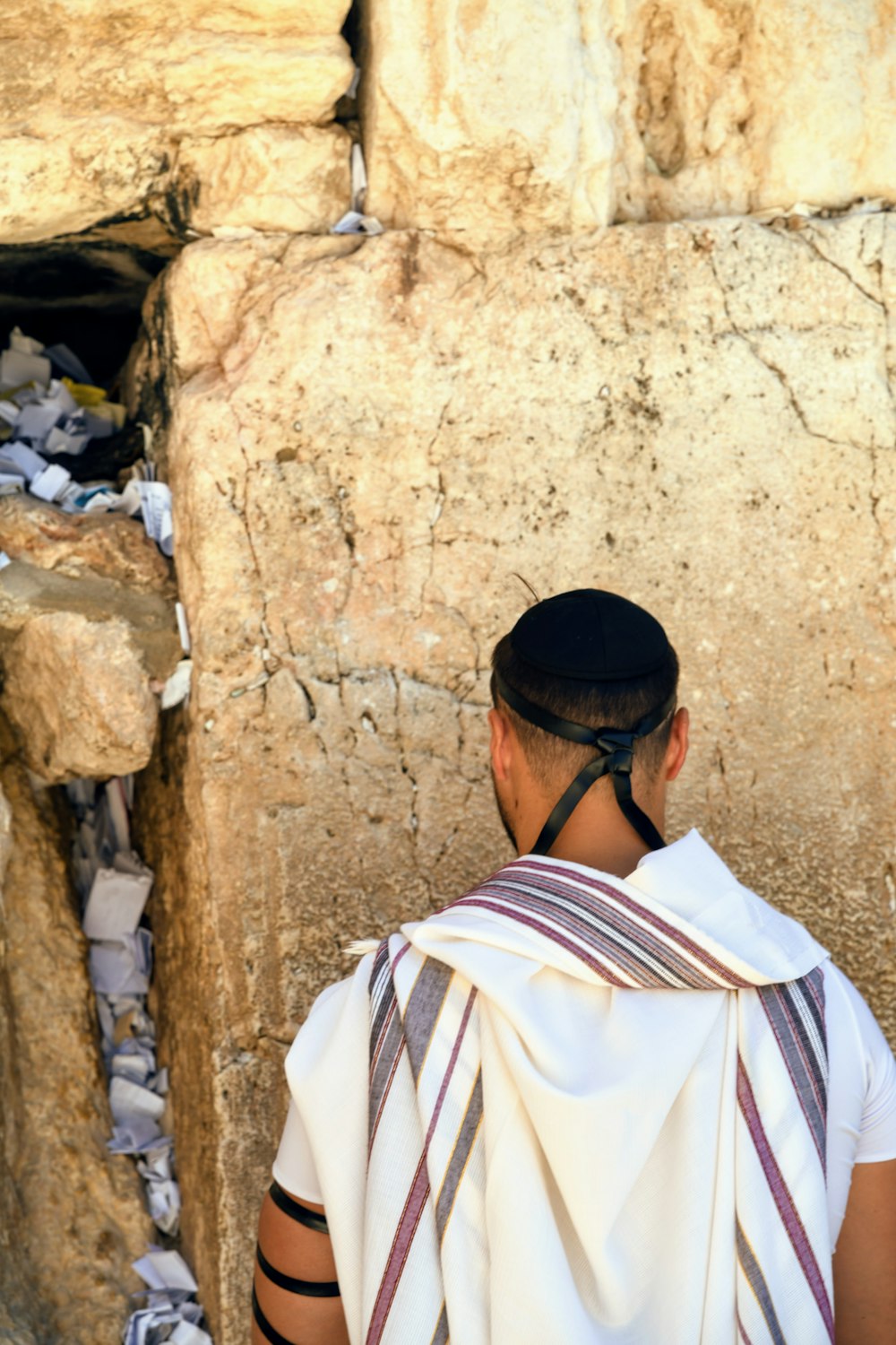 a man looking at a rock wall