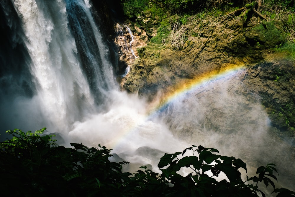 a waterfall with a rainbow