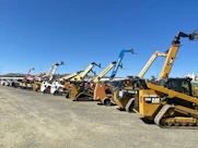 a group of yellow and black construction vehicles