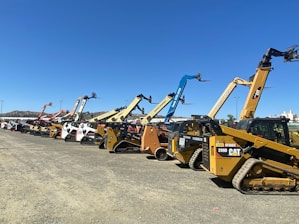 a group of yellow and black construction vehicles
