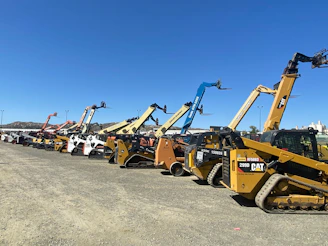 a group of yellow and black construction vehicles