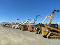 a group of yellow and black construction vehicles