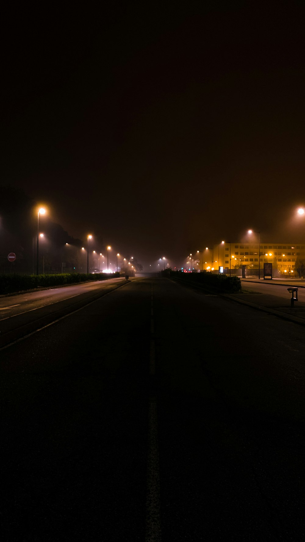 a road with street lights at night