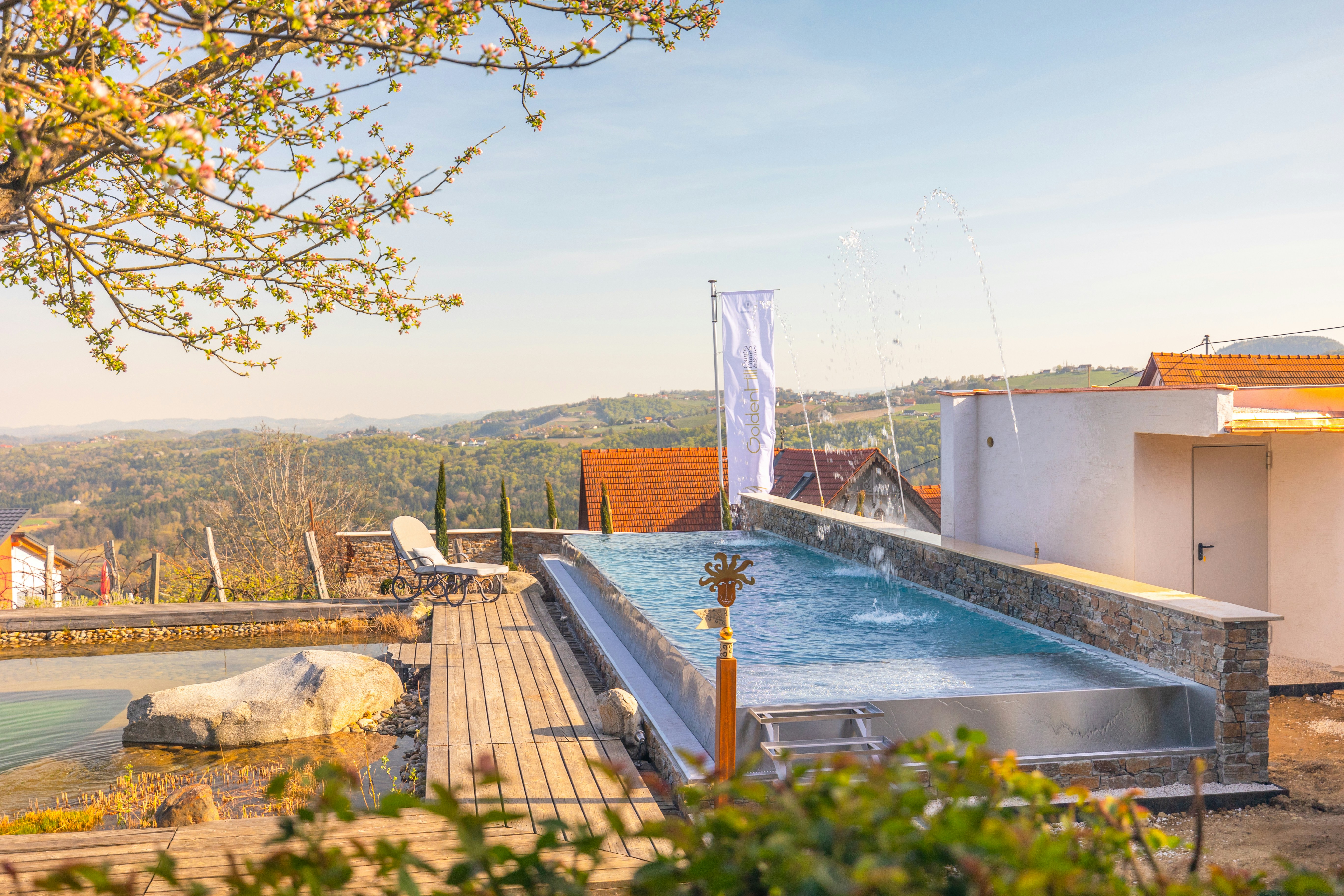 a swimming pool with a deck and trees in the background