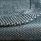 Close-up of a finely textured fabric from a ja wears by as jacket, highlighting craftsmanship.