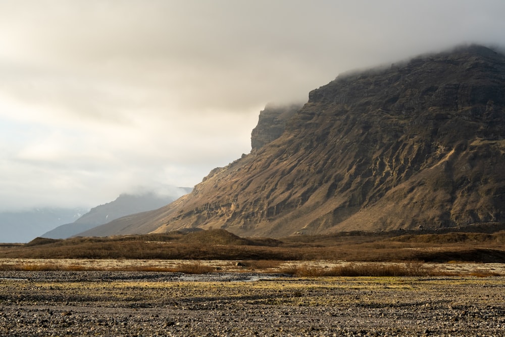 a large mountain with a valley below