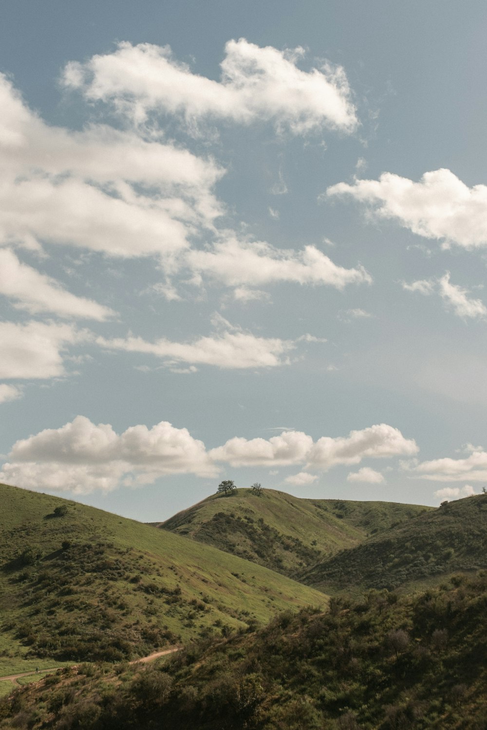 a landscape with hills and clouds