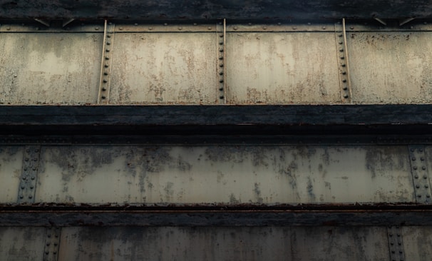 Close-up of a zinc-rich primer coating applied to industrial steel beams, highlighting texture and finish.