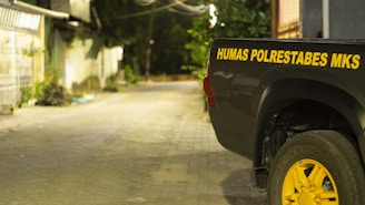 A Talbert's Towing truck assisting a stranded vehicle on a quiet Chapel Hill street at dusk.
