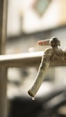 A close-up of a faucet being repaired with tools.