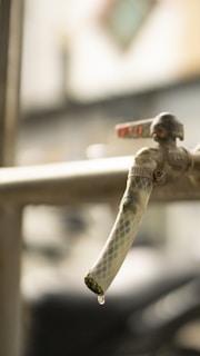 A close-up of a handyman repairing a faucet.