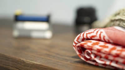 Close-up of folded industrial wiping rags on a wooden workbench.