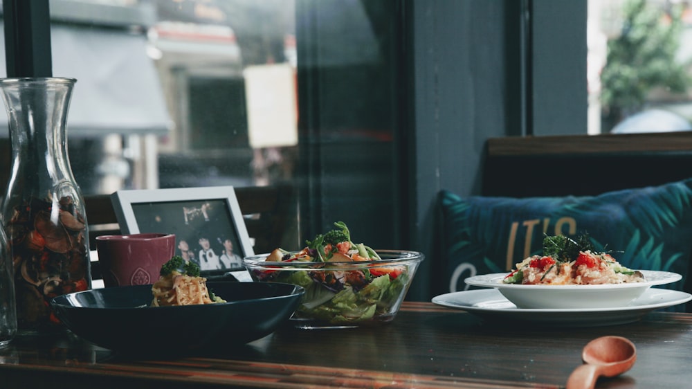 a table with plates of food and a picture on it