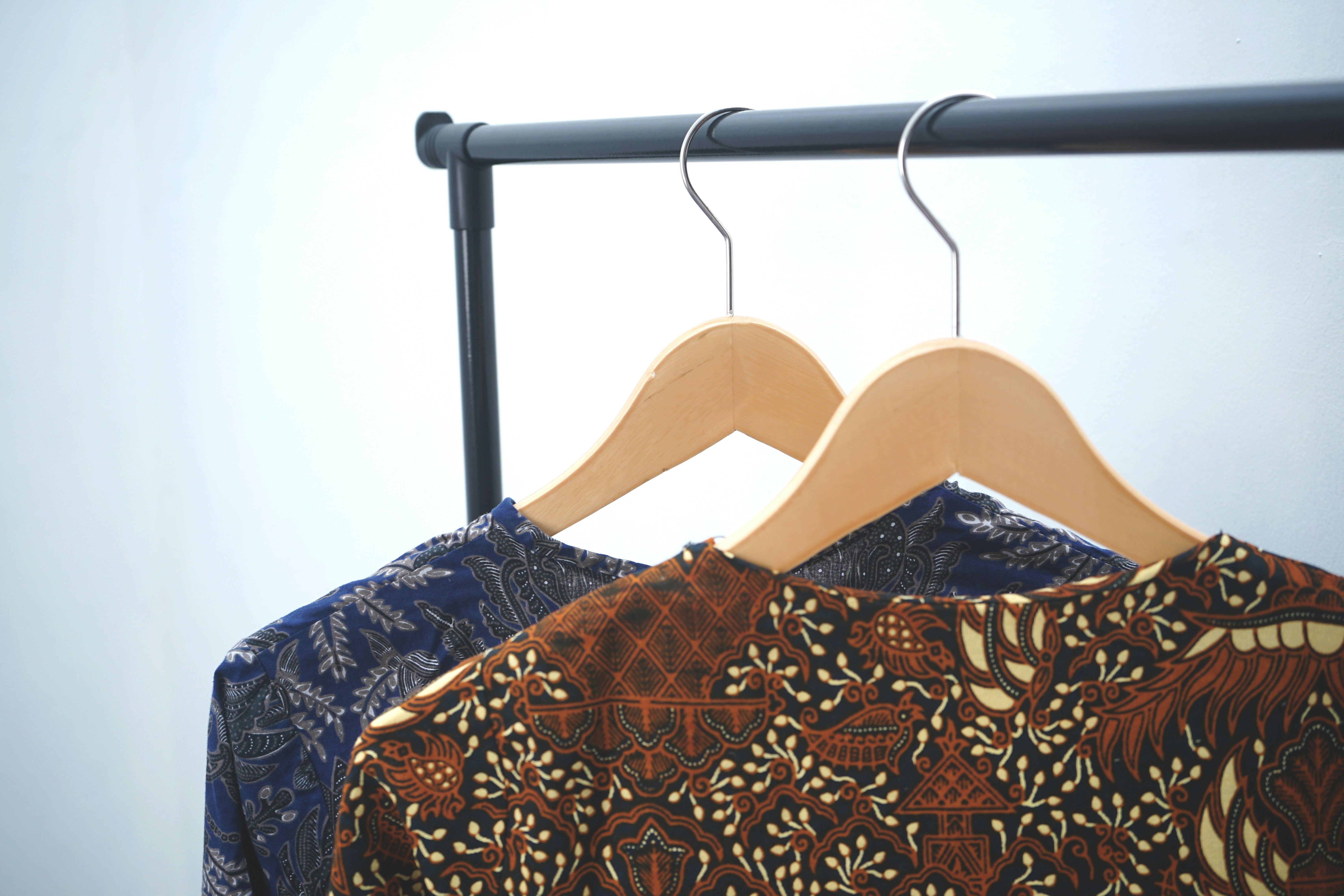 Double Hanging Rods In A Closet With Shirts On Top And Skirts Below
