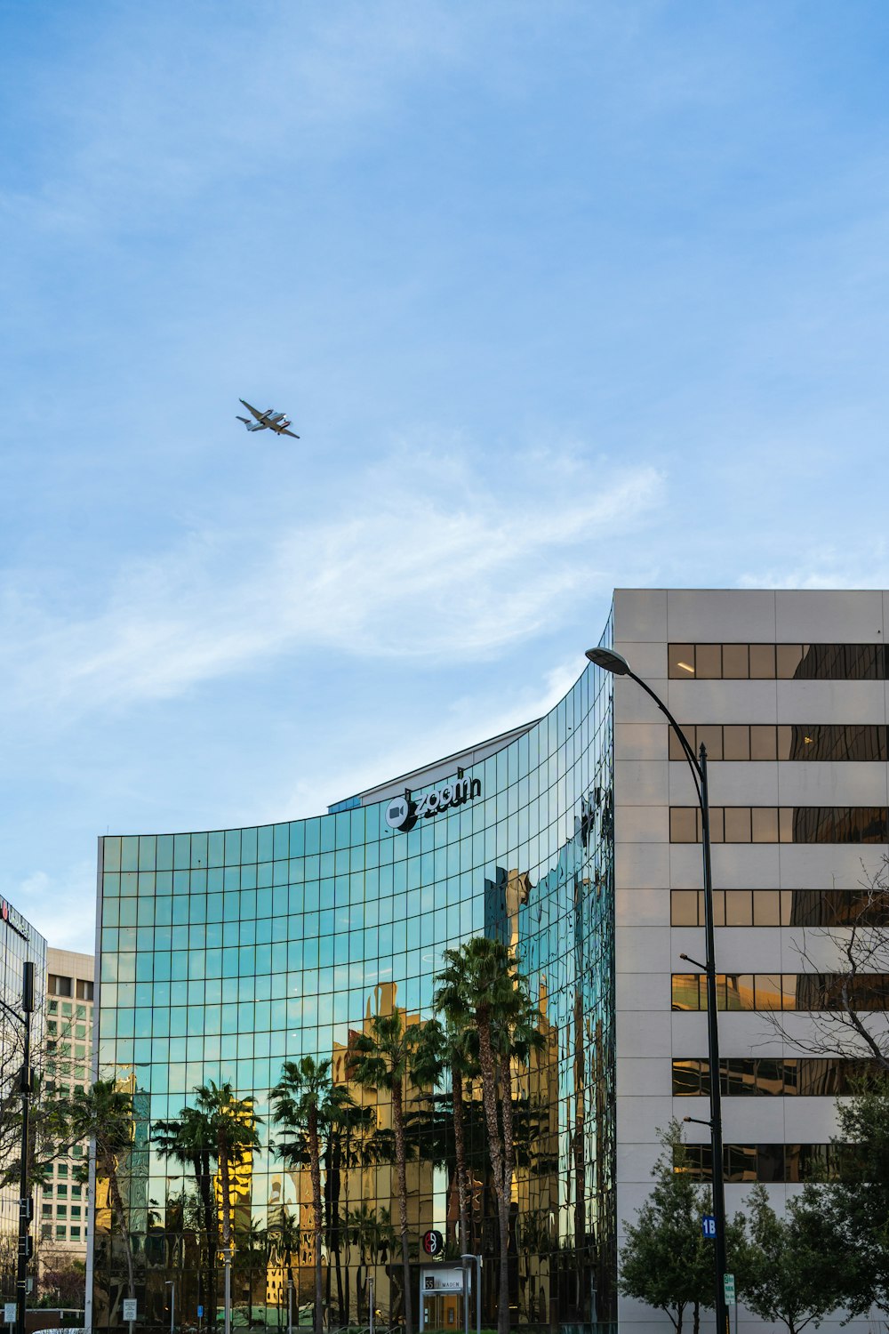 a plane flying over a large building