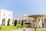 a white building with a green lawn
