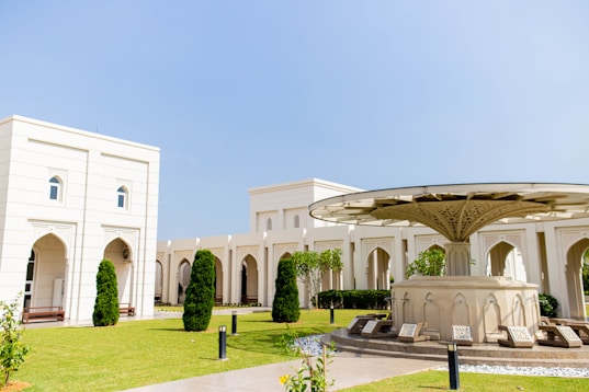 a white building with a green lawn